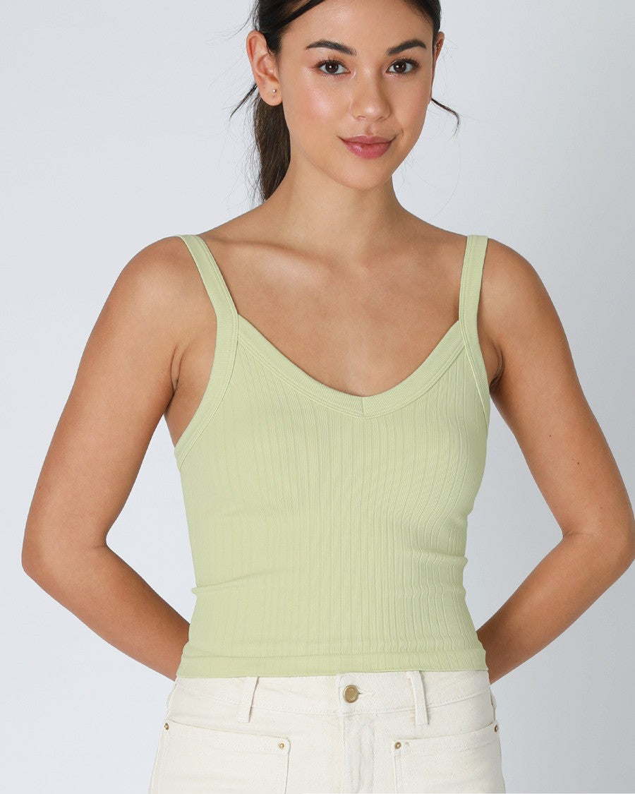Woman wearing a light green tank top with text '2230 Pistachio Cream' on a white background