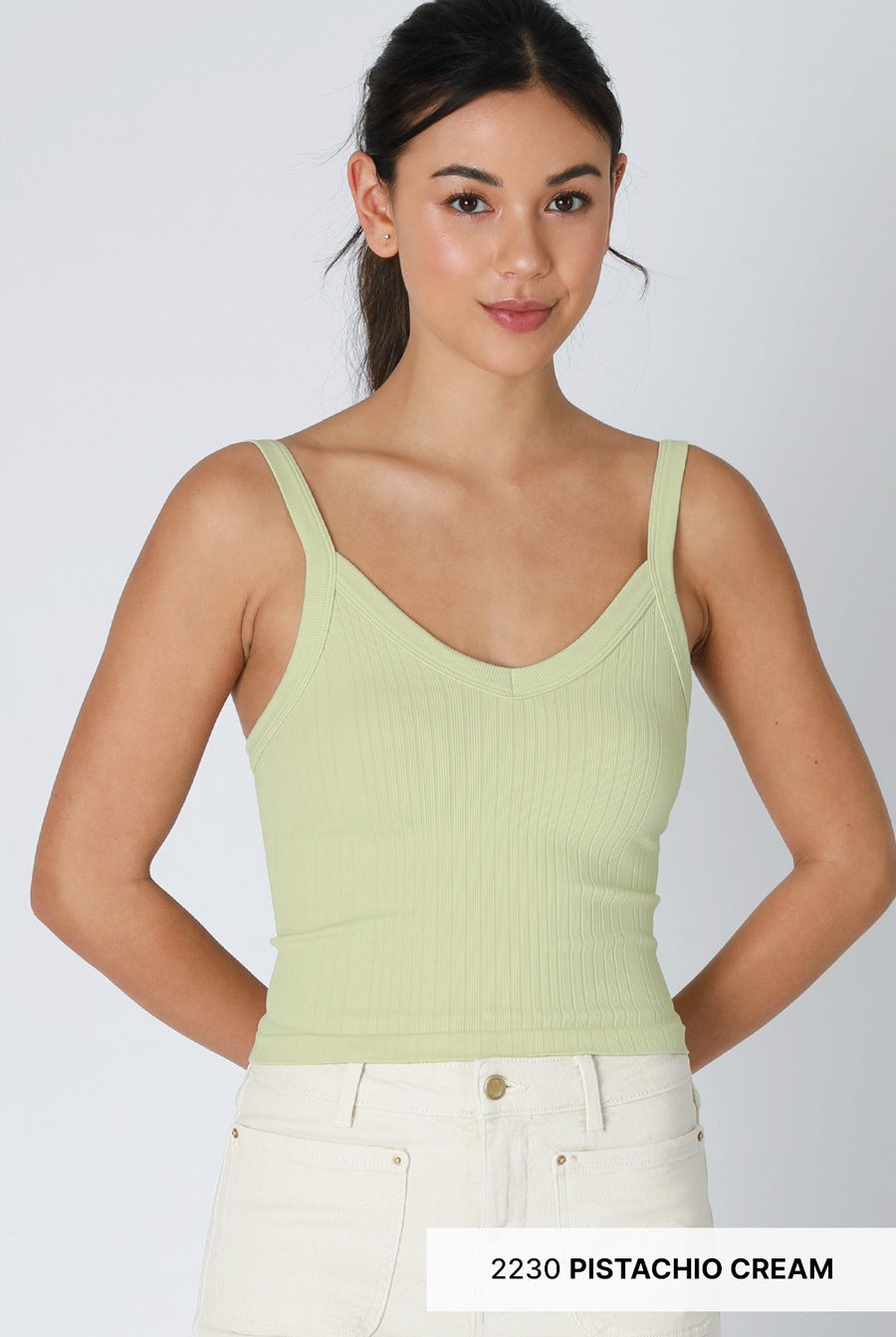 Woman wearing a light green tank top with text '2230 Pistachio Cream' on a white background